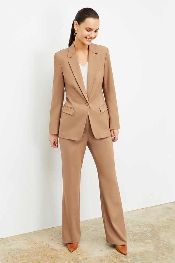 Front image of a woman standing wearing the Yiyan Blazer in Camel | Exclude