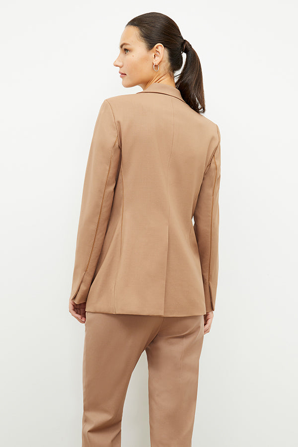Front image of a woman standing wearing the Yiyan Blazer in Camel | Exclude