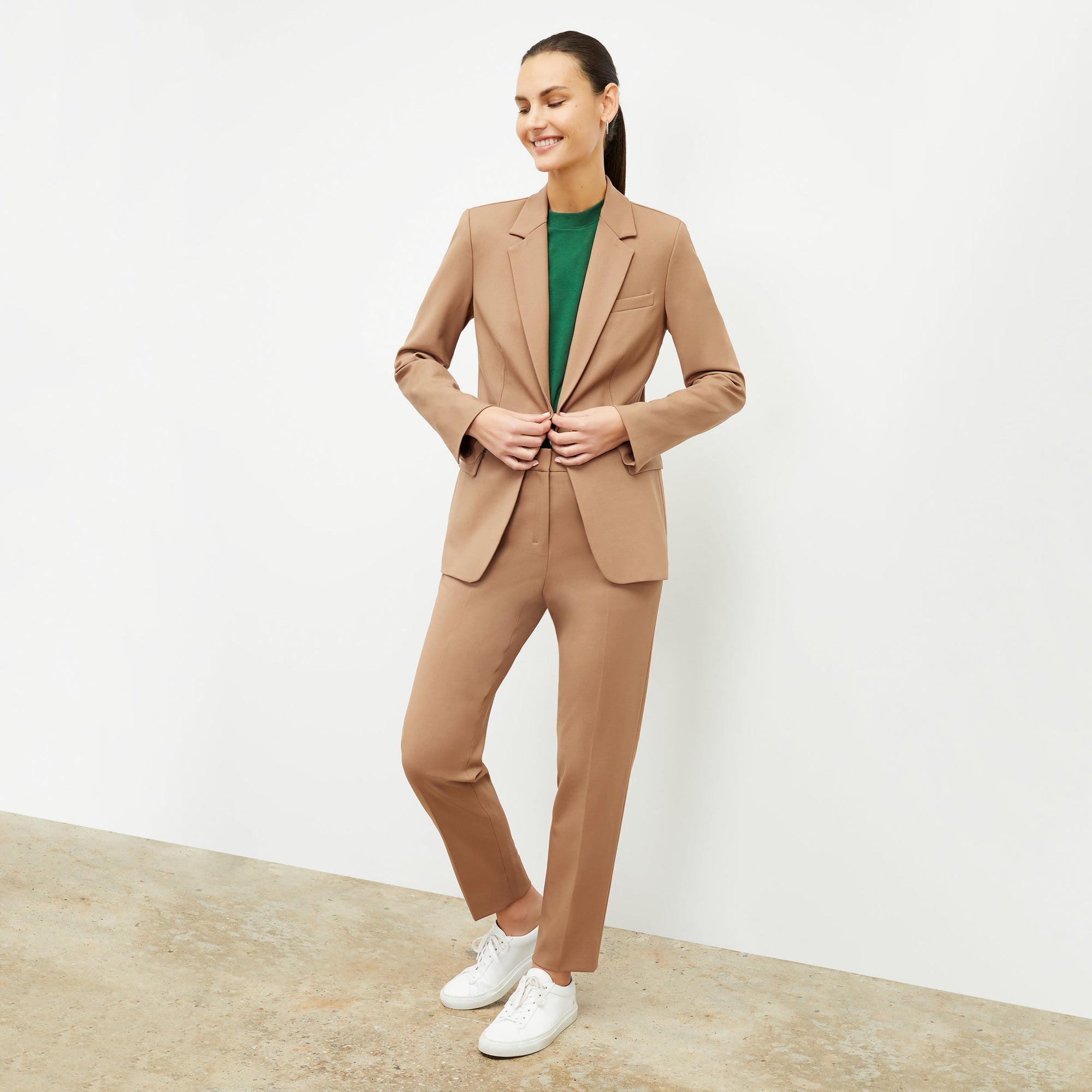 Front image of a woman standing wearing the Yiyan Blazer in Camel | Exclude