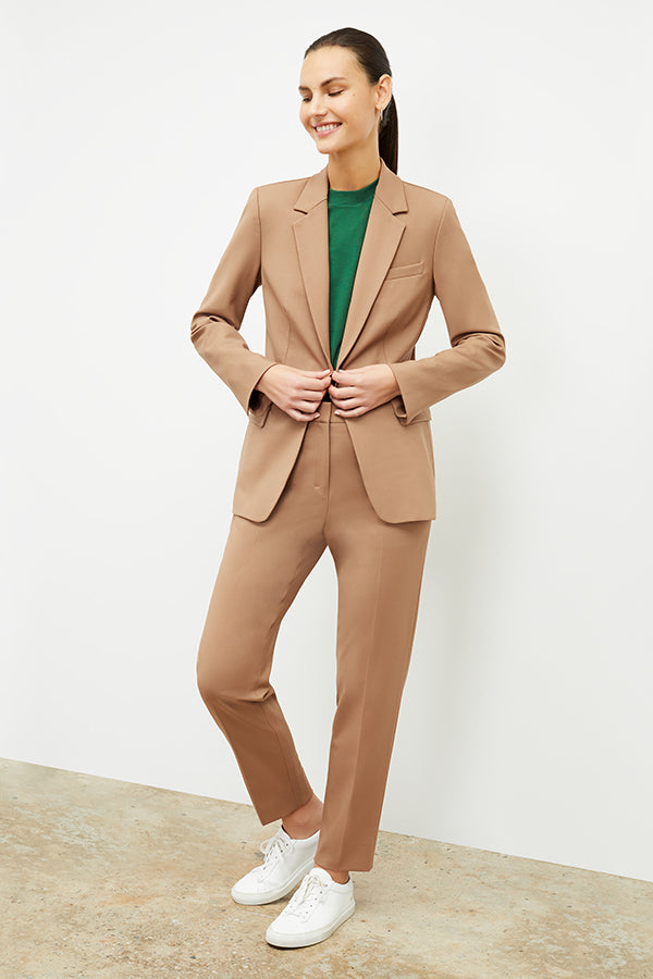 Front image of a woman standing wearing the Yiyan Blazer in Camel | Exclude