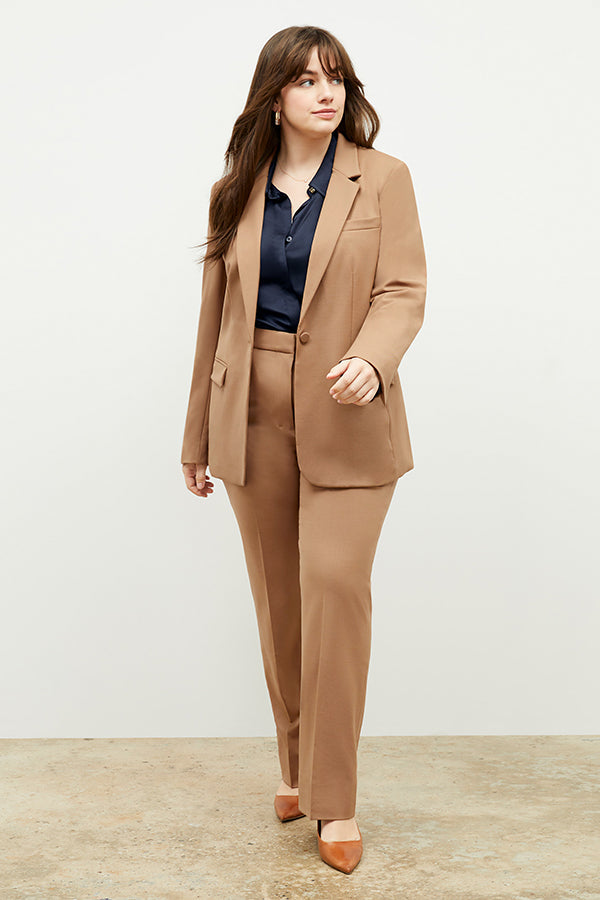 Front image of a woman standing wearing the Yiyan Blazer in Camel | Exclude