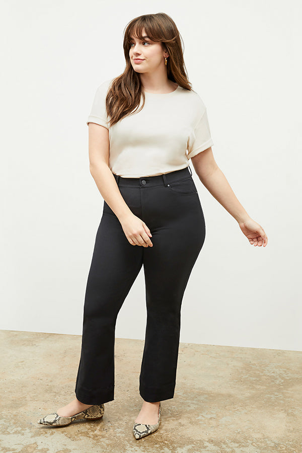 Front image of a woman standing wearing the leslie top in compact cotton in ivory | Exclude
