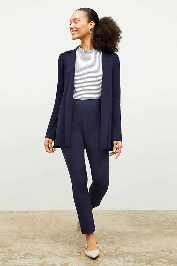 Front image of a woman standing wearing the foster pant in dark navy | Exclude
