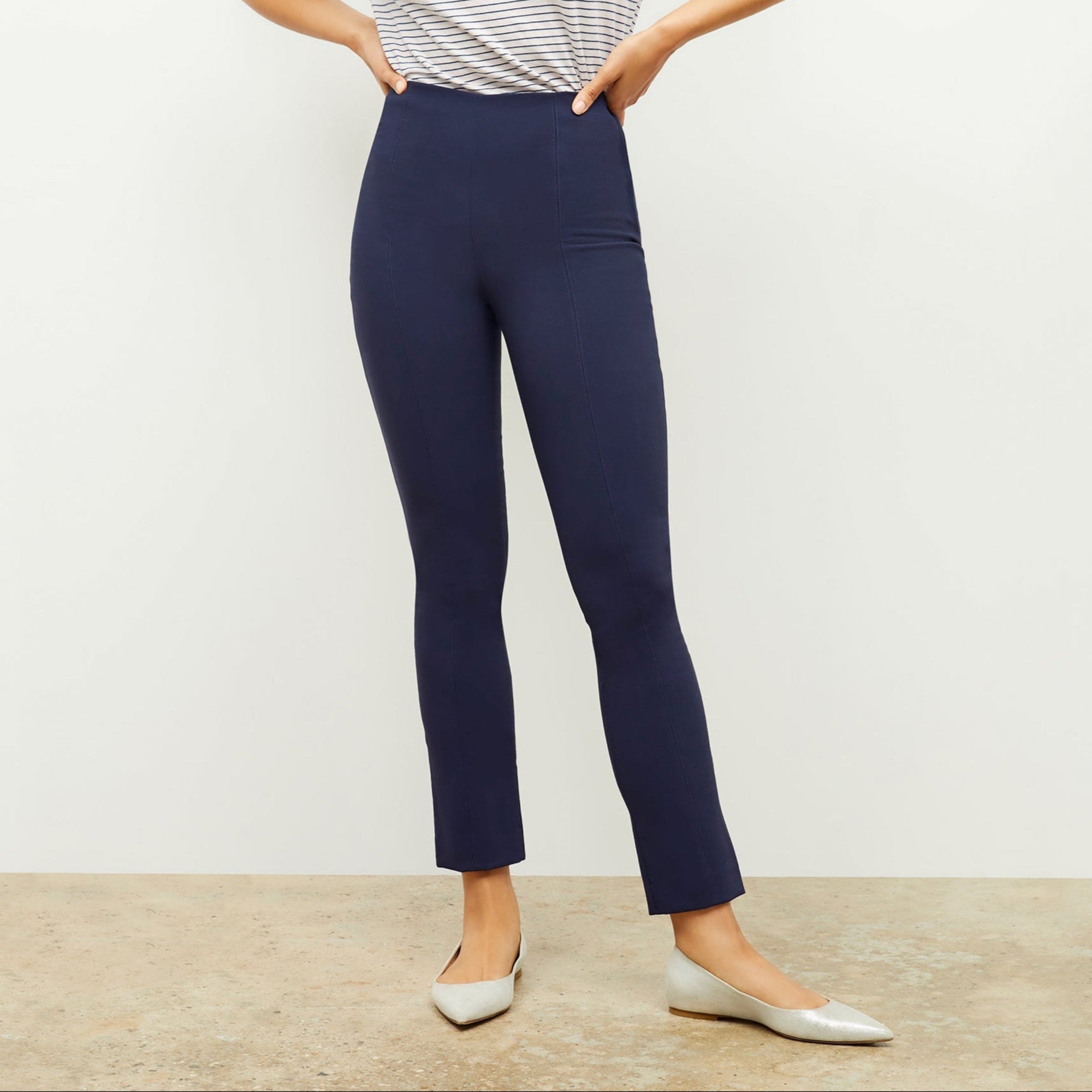 Front image of a woman standing wearing the foster pant in dark navy | Lead