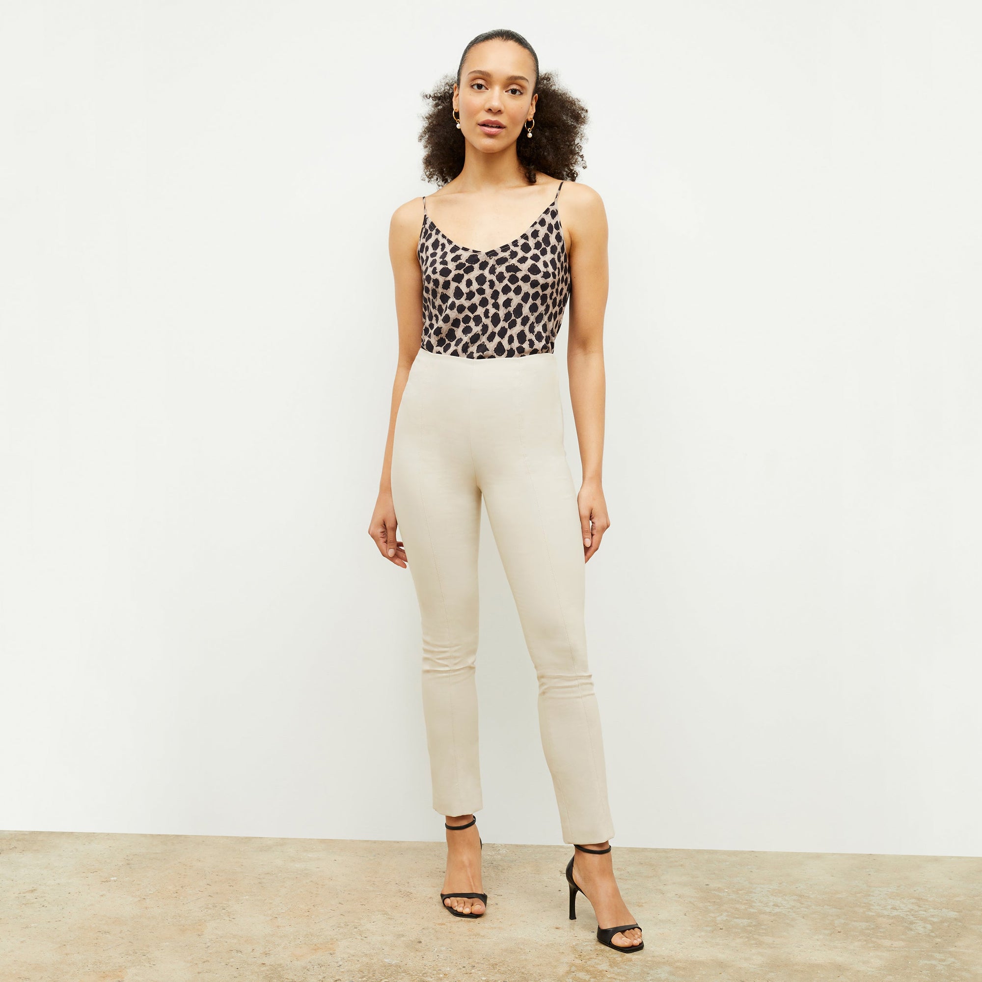 Front image of a woman standing wearing the Lisey Cami—Sahara Print Washable Silk in Tan/Black | Exclude