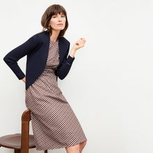 front image of a woman wearing the sant ambroeus jardigan in navy