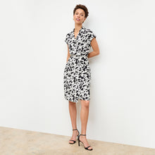 front image of a woman wearing the tory dress in icon print | Lead