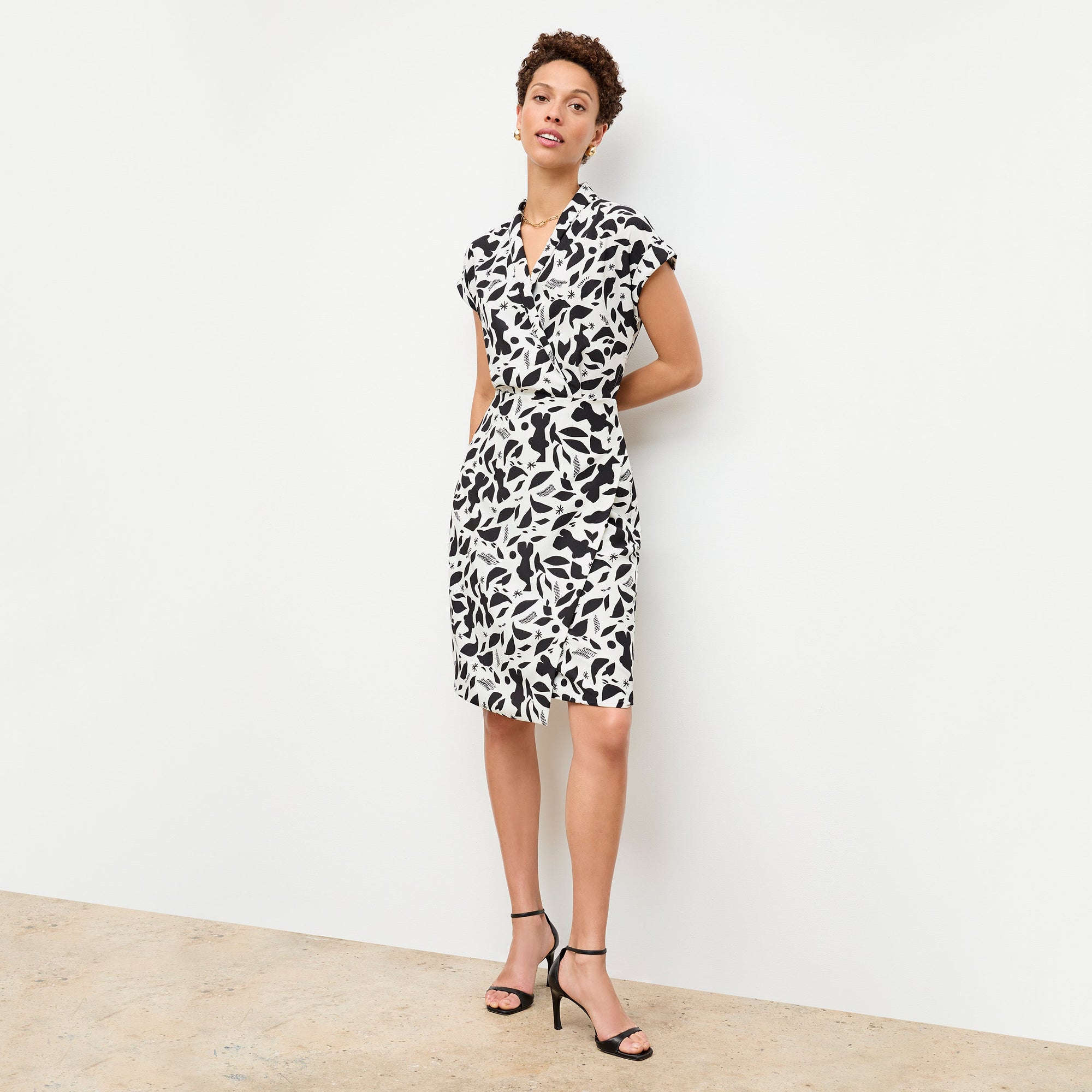 front image of a woman wearing the tory dress in icon print | Lead