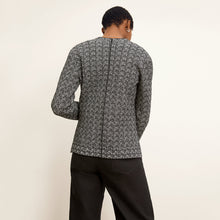 back image of a woman wearing the woolf jardigan in black/ivory