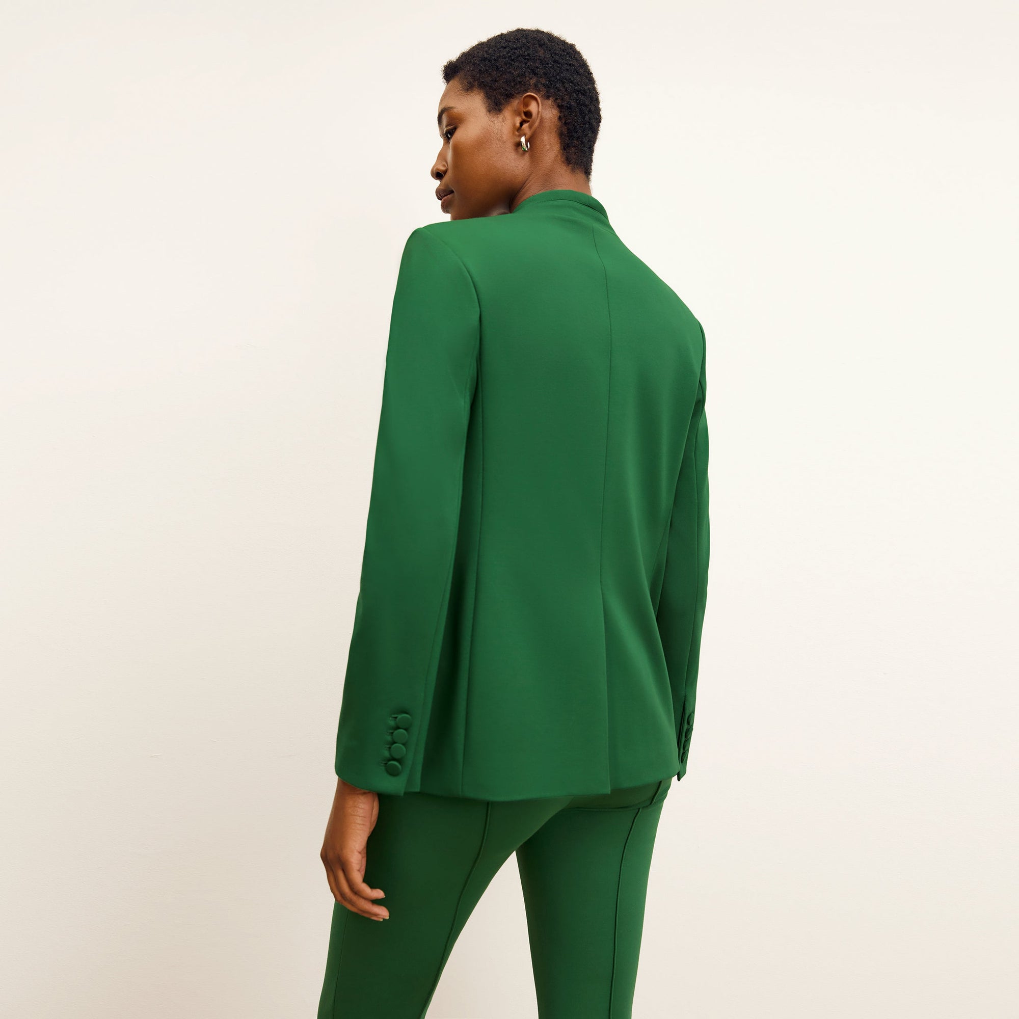 back image of a woman wearing the janette jacket in shamrock 
