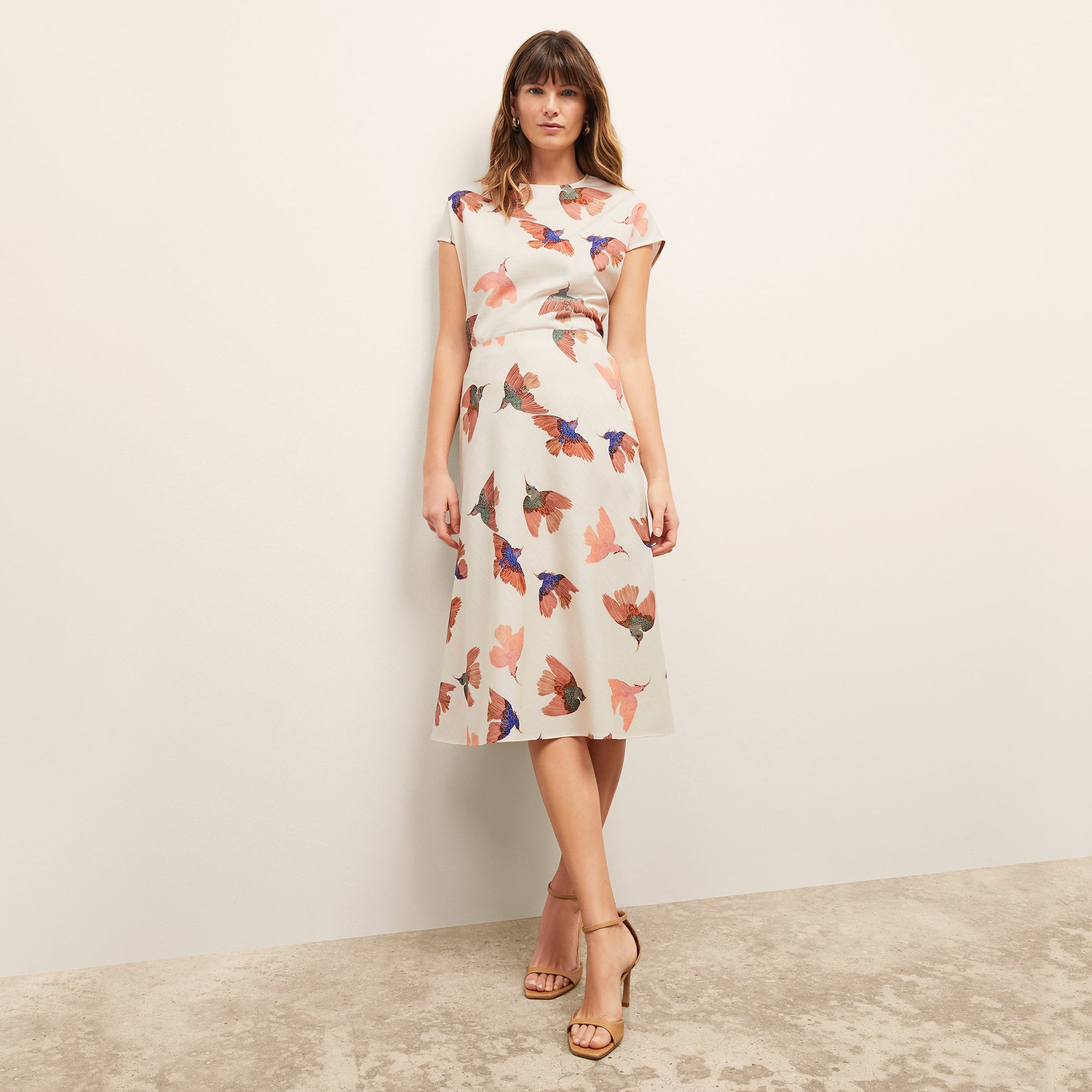 front image of a woman wearing the orchard skirt in hummingbird print