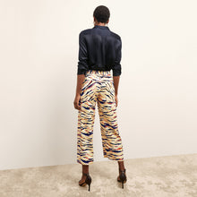 back image of a woman wearing the madelyn pant in savannah print