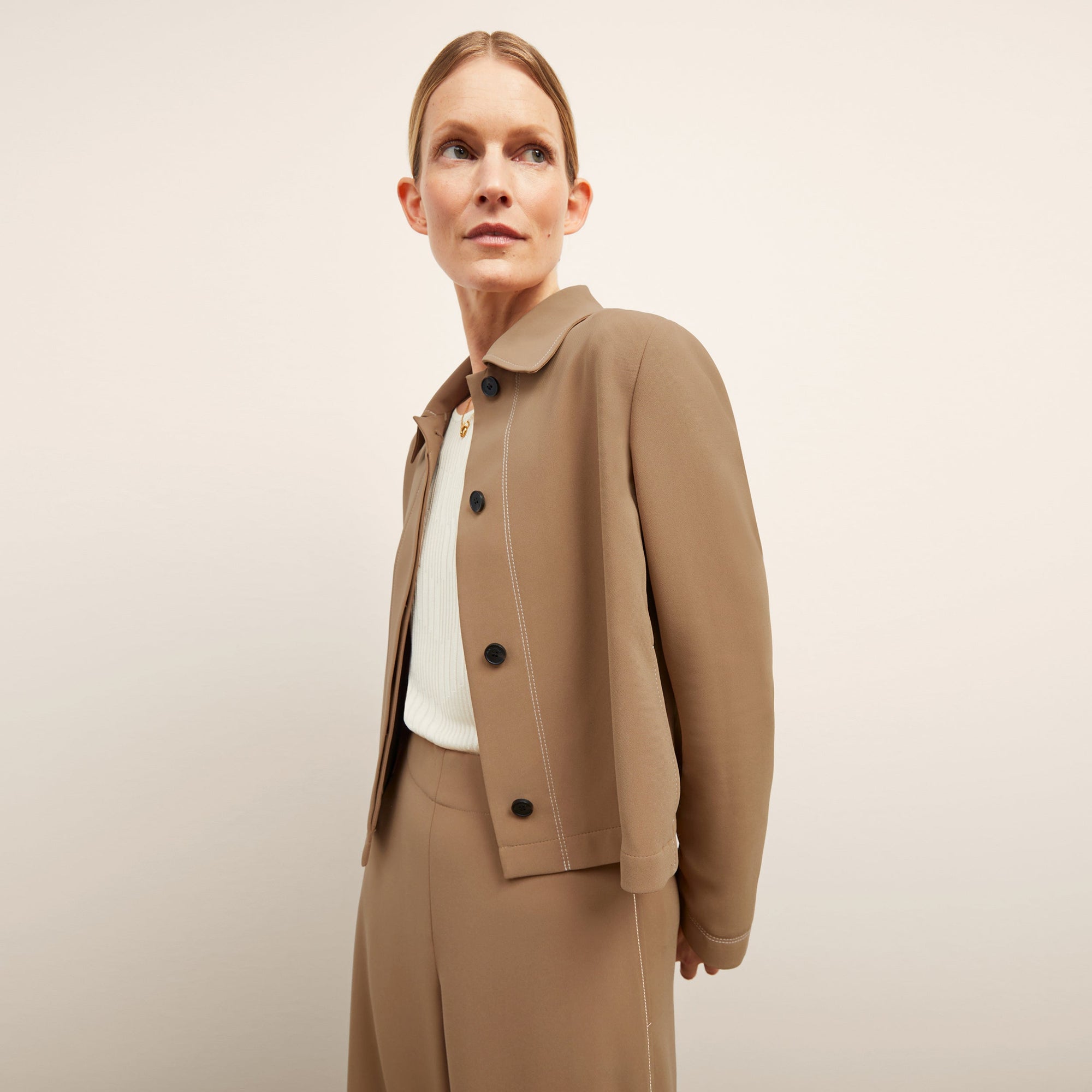 front image of a woman wearing the nicky jacket in saddle | Lead