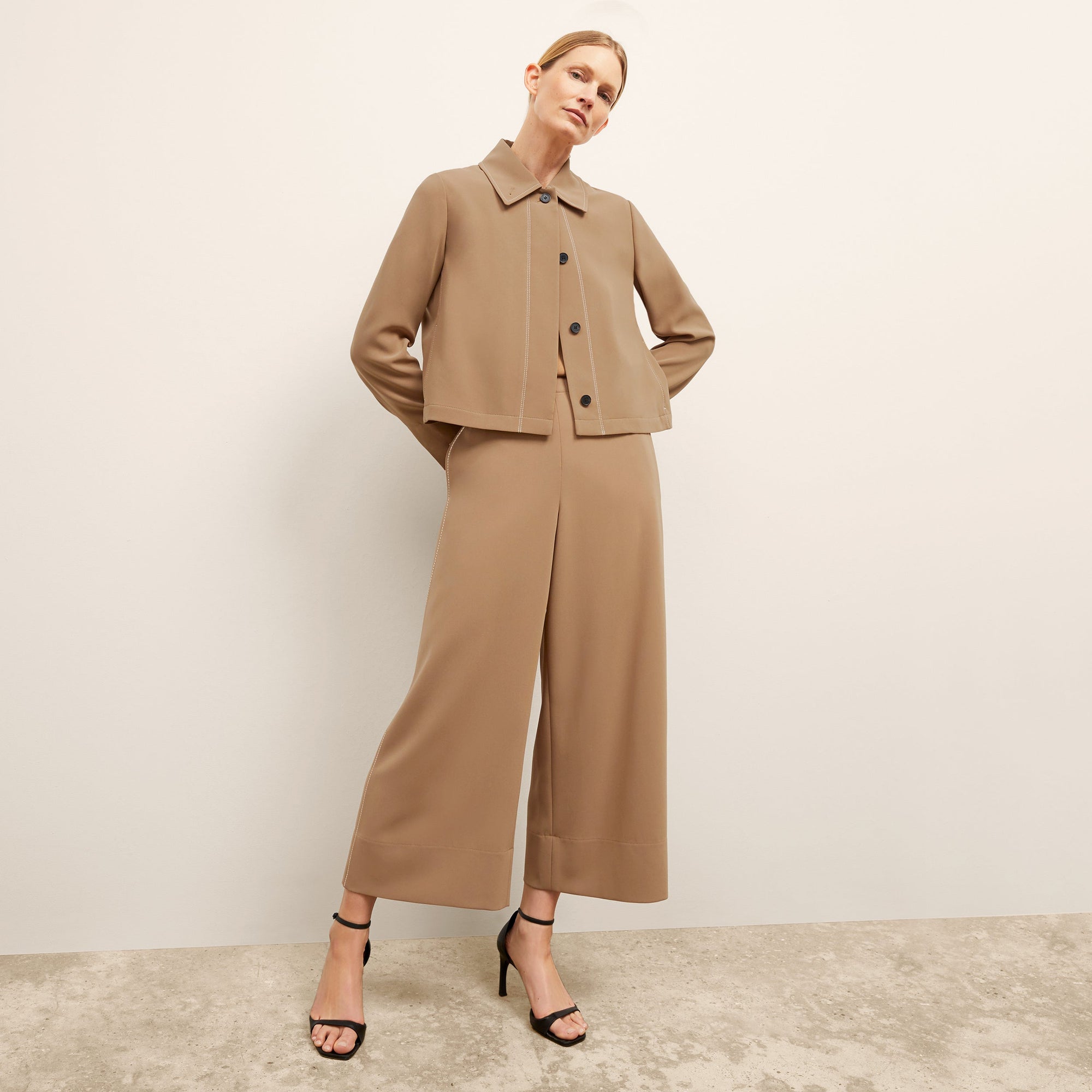 front image of a woman wearing the nicky jacket in saddle