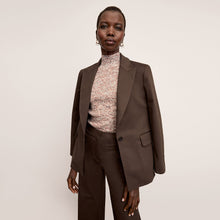 Front image of a woman wearing the Tyner jacket in stretch chino in date