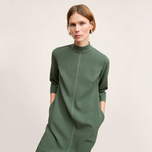 front image of a woman wearing the kinsley dress in dusty pine