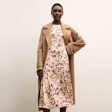 front image of a woman wearing the nyla dress in botanical print 