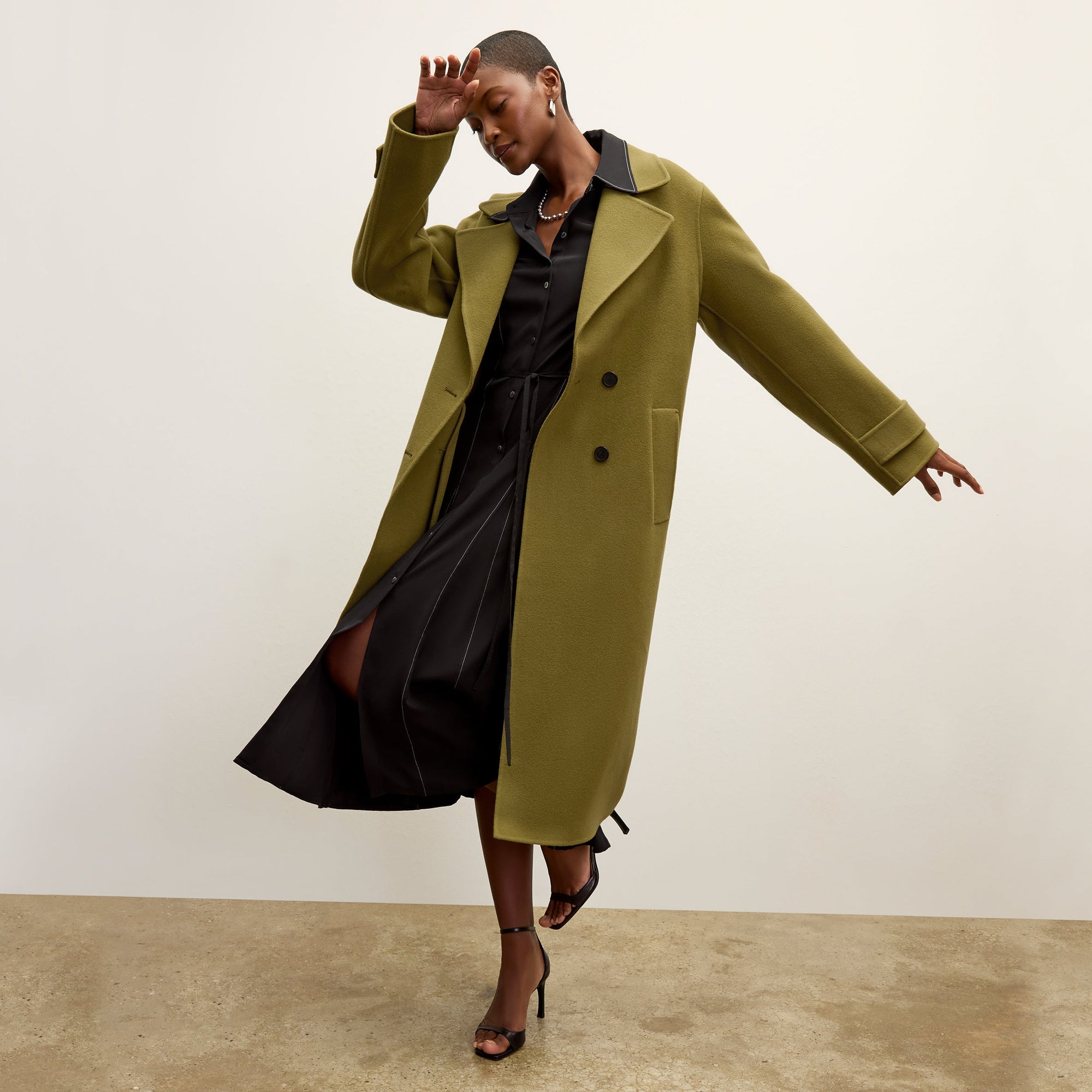 front image of a woman wearing the pepper dress in black
