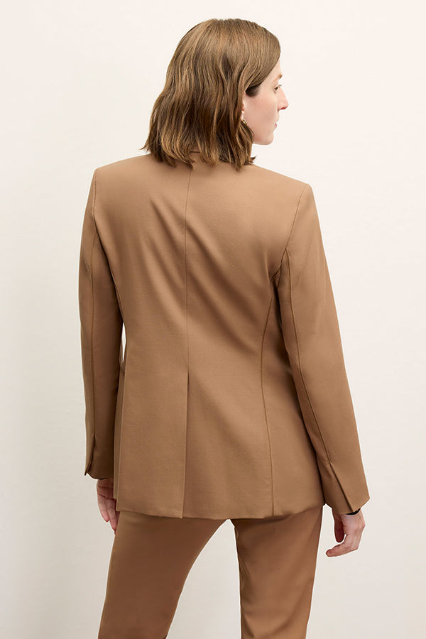 Back image of a woman standing wearing the Yiyan Blazer in Camel | Exclude | Grid Hover