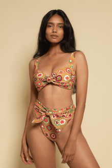 Floral tie-up bikini bottom in red, yellow, and green with multicolored flower print and side tie closures.