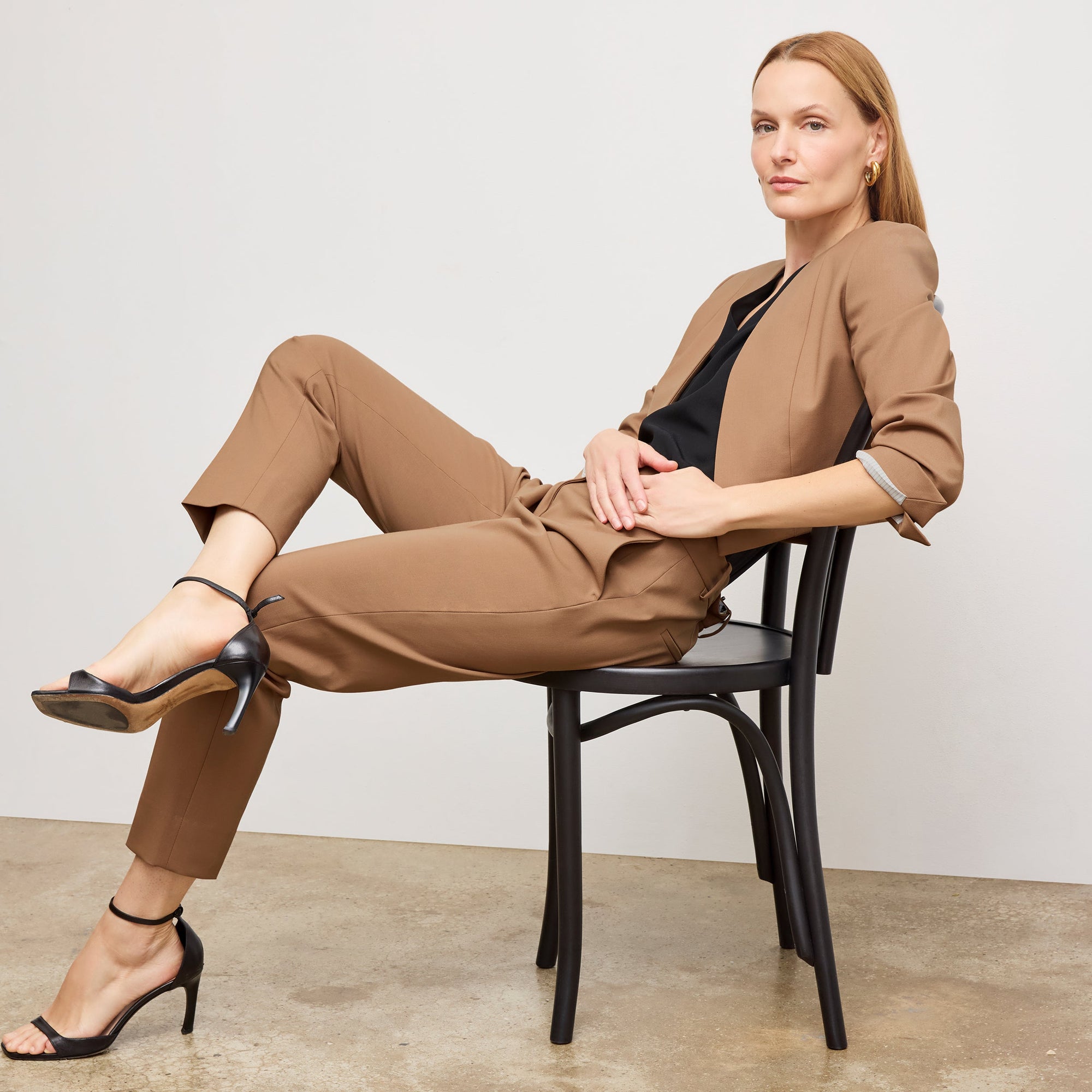 Front image of a woman standing wearing the Neale jacket in camel