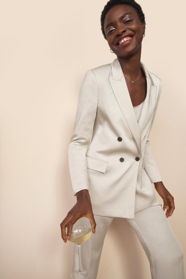 mood image of a woman wearing the ohara jacket in champagne | Exclude