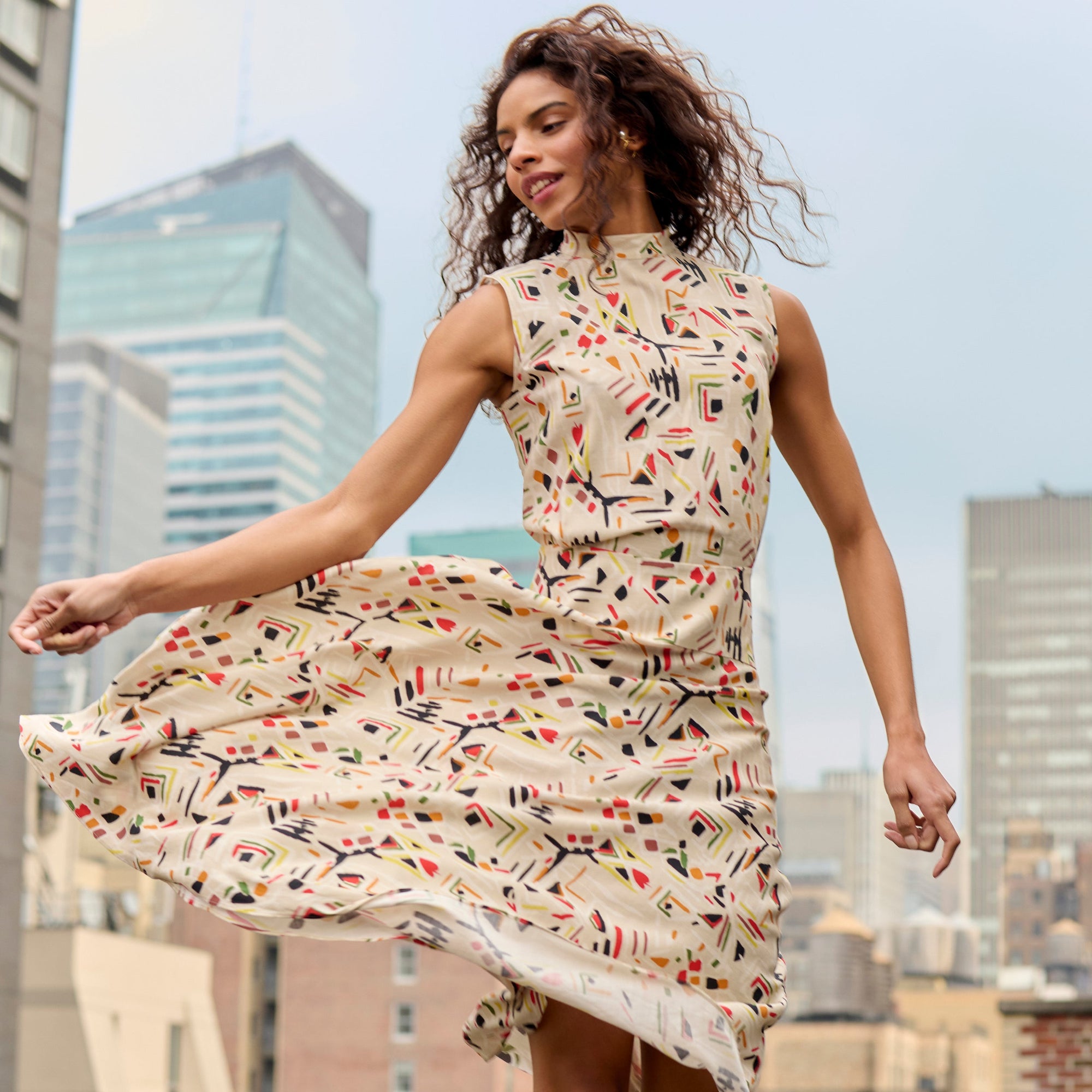 front image of a woman wearing the oona dress in rhythm print