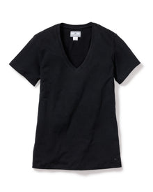 The Womens Pima Short Sleeve Top in Black by Petite Plume, made from soft Peruvian Pima cotton jersey knit, stands out on a white background. This simple, elegant V-neck with short sleeves has a white tag in the neckline at the back, highlighting its quality craftsmanship.