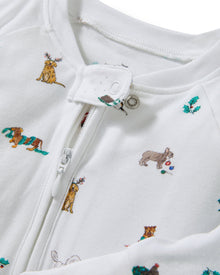 The Baby's Pima Peekaboo Romper in Jingle Paws is a white, long-sleeve onesie with a front zipper, decorated with colorful dogs and green bones. The left leg appears slightly folded over.
