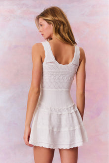 Mini dress featuring scallop detail through the stitch and edge. With a little bit of stretch, thereâ€™s cinching at the waist before falling to a full skirt with a scallop trim.