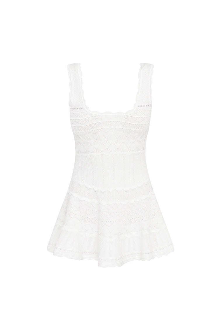 Mini dress featuring scallop detail through the stitch and edge. With a little bit of stretch, thereâ€™s cinching at the waist before falling to a full skirt with a scallop trim.