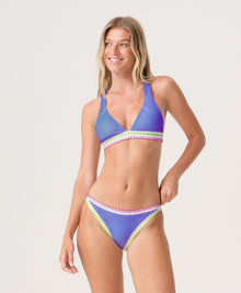 Woman wearing a blue bikini with colorful crochet trim set on a white background