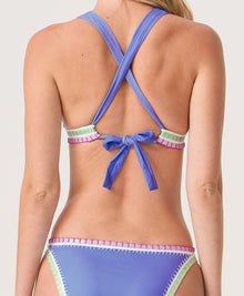 Woman wearing a blue bikini with colorful crochet trim set on a white background