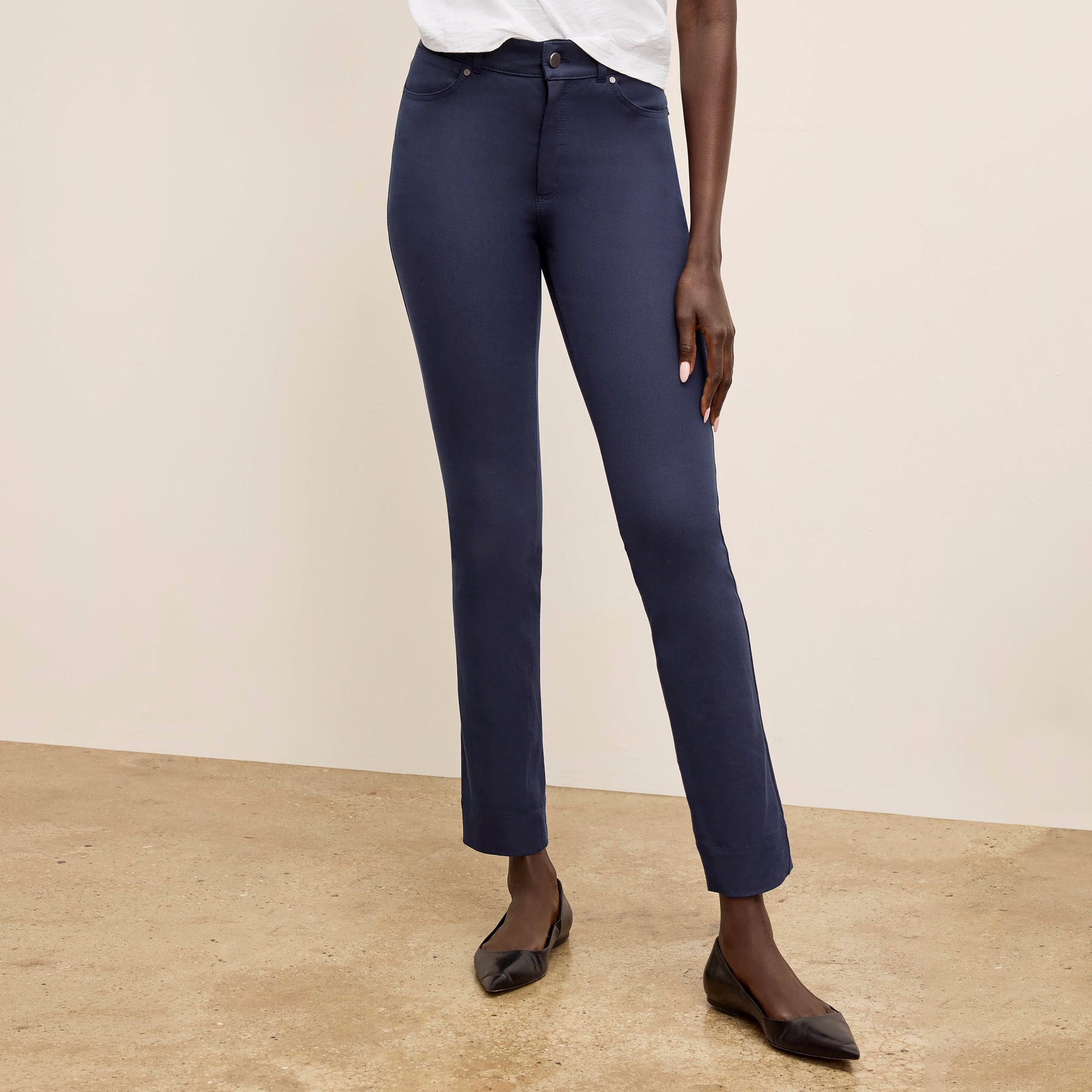Front image of a woman wearing the roma pants in dark navy