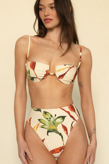 Cream bikini top with red and yellow floral print, underwire cups, and thin shoulder straps.