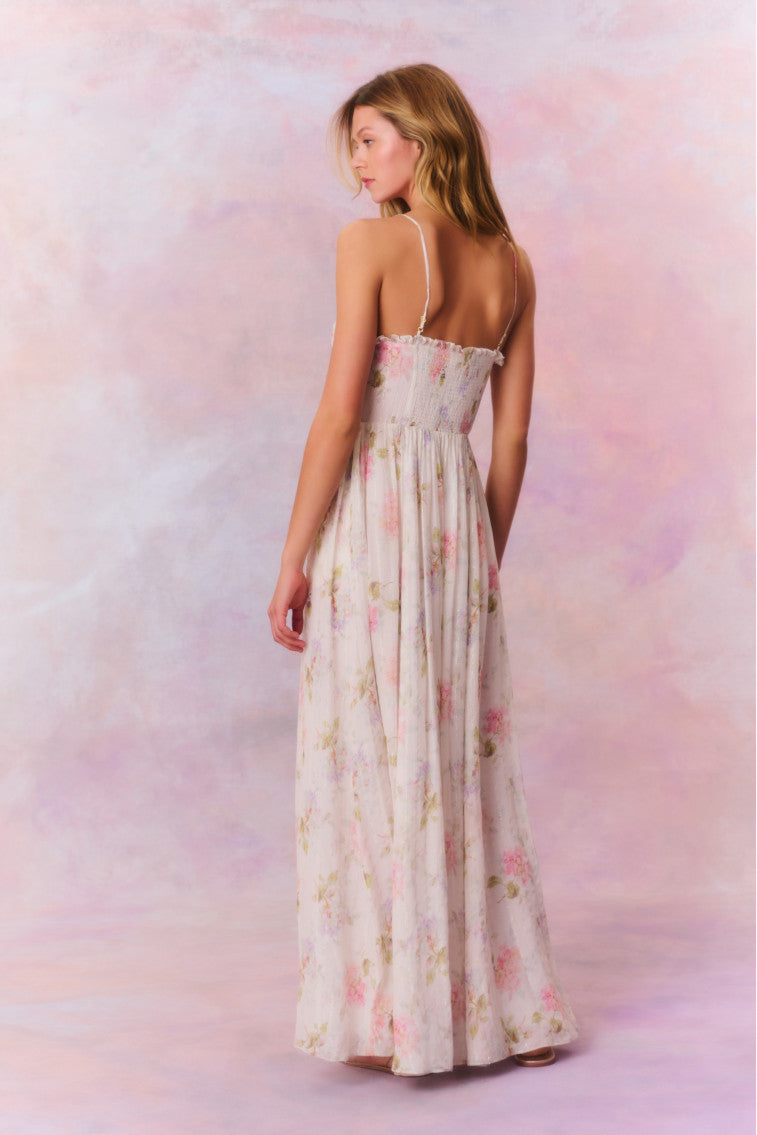 Maxi dress with ruched detailing at the top with ruffle detail at the neckline. The piece is finished with a sweeping shirred skirt and a smocked back for an easy and comfortable fit.