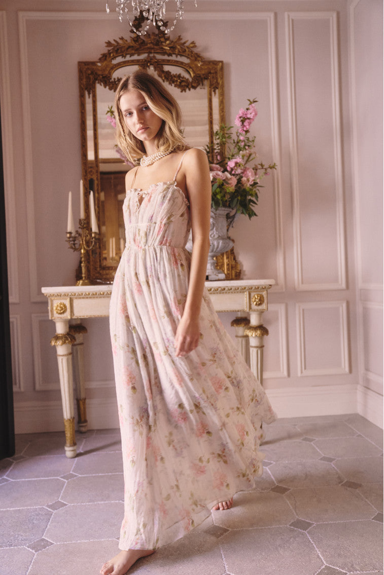Maxi dress with ruched detailing at the top with ruffle detail at the neckline. The piece is finished with a sweeping shirred skirt and a smocked back for an easy and comfortable fit.