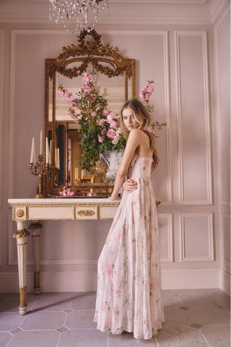 Maxi dress with ruched detailing at the top with ruffle detail at the neckline. The piece is finished with a sweeping shirred skirt and a smocked back for an easy and comfortable fit.