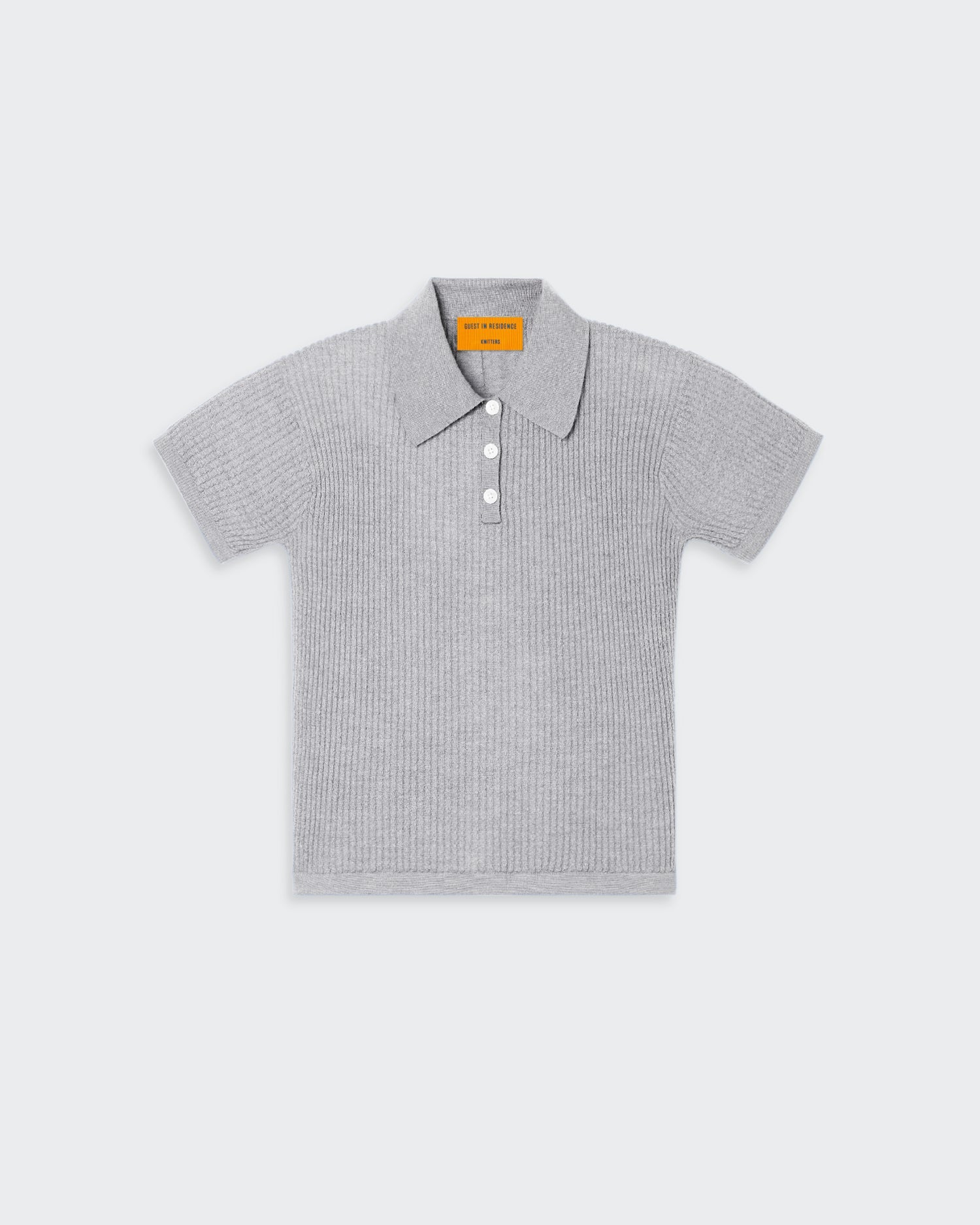A grey women's polo shirt with a three-button front placket, textured waffle stitch, and signature branding at the center back neck.