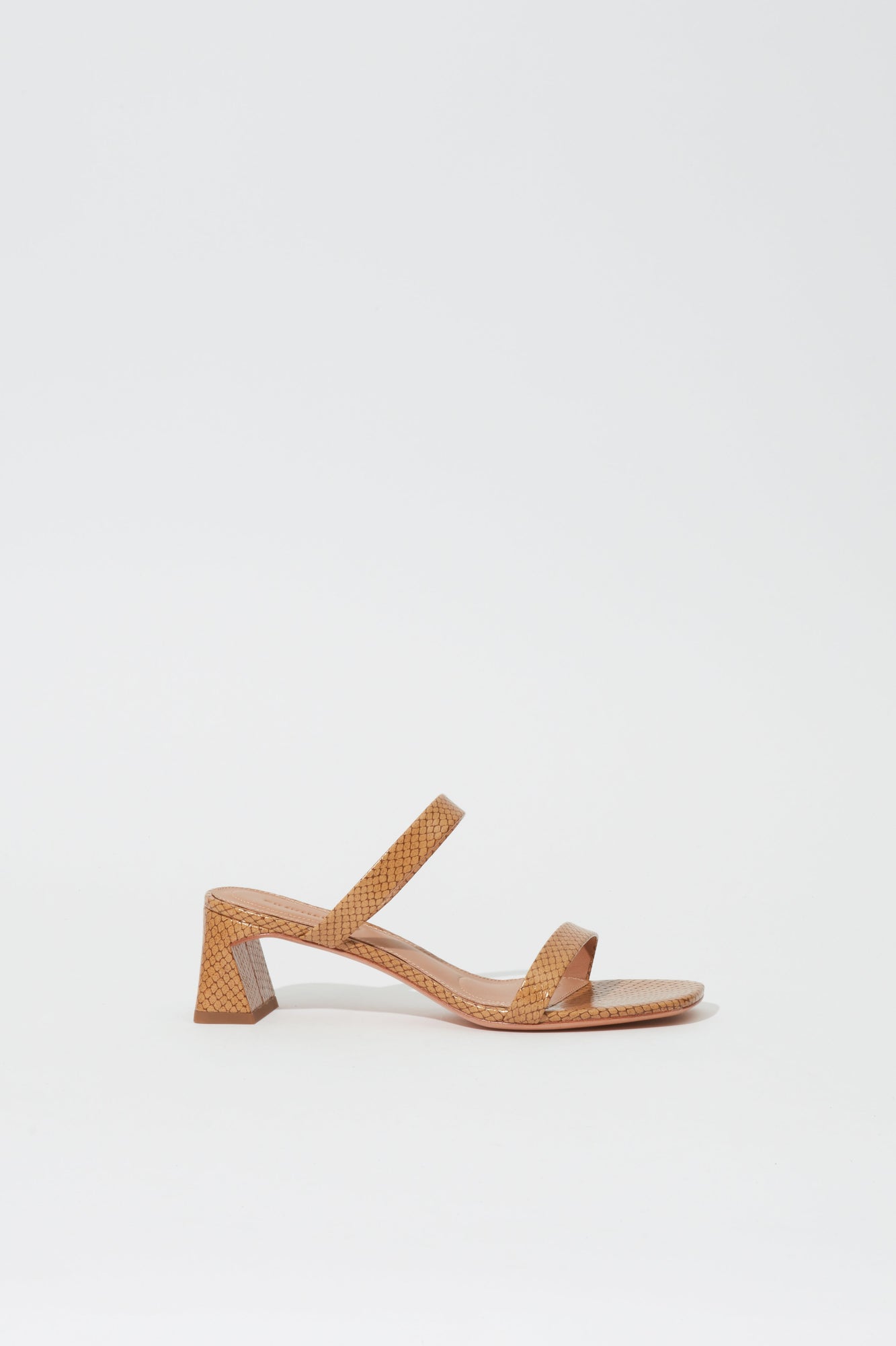 Tan leather sandal with debossed quilted pattern, ankle strap, and chunky block heel.