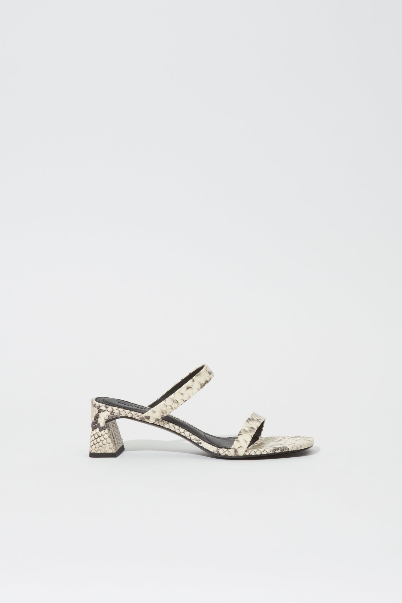 Cream and black snake-print sandal with ankle strap and chunky block heel.