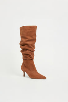 Tan suede knee-high boot with gathered slouch detailing and thin heel.