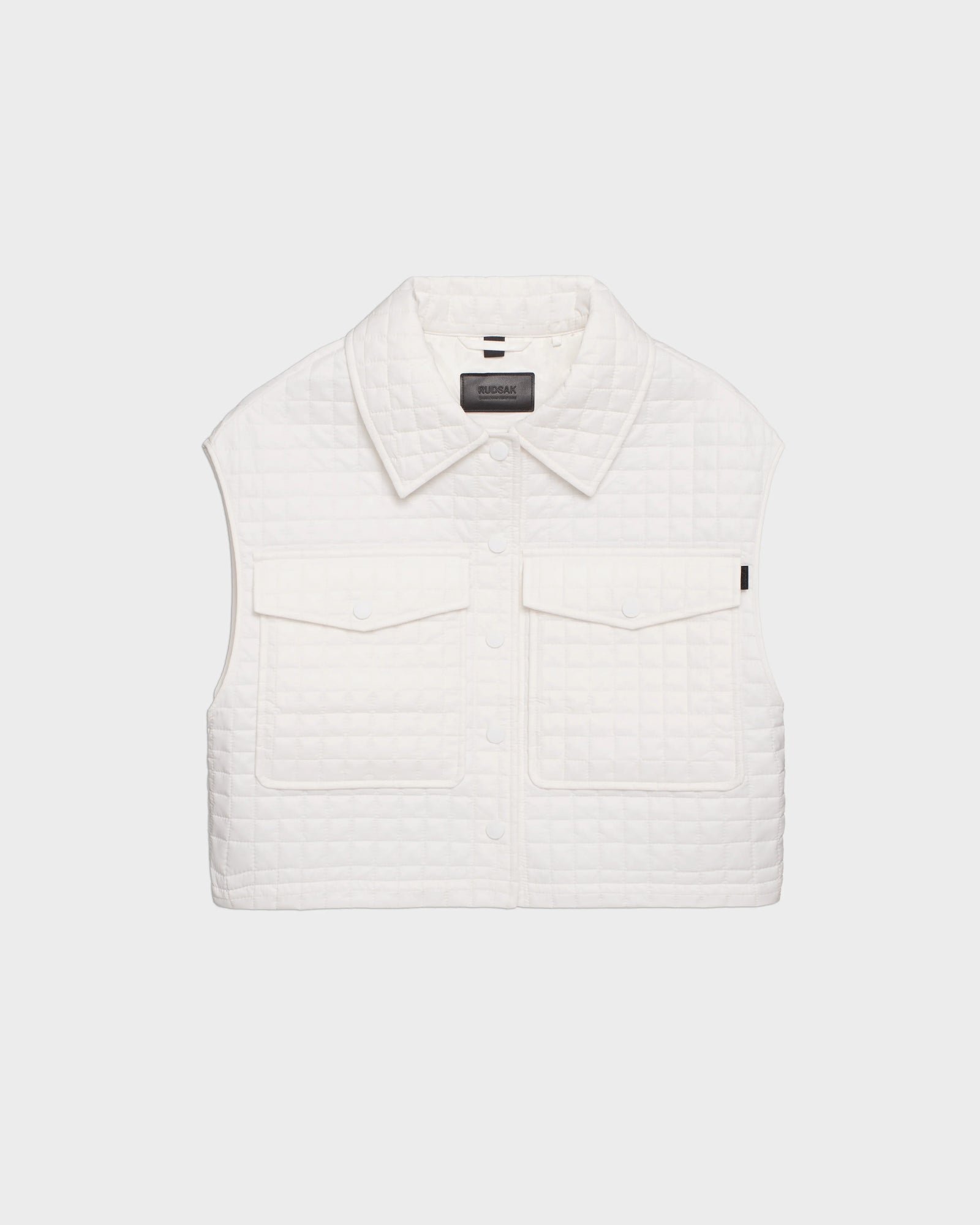 The SOLSA - 8124048 Eggshell by Rudsak is a womens sleeveless, white cropped quilted vest with eco-friendly Sorona fill, collar, two front flap pockets, and snap buttons, shown against a plain white background.