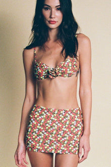 Floral bikini top with red, white, and yellow small flowers in an all-over pattern, featuring adjustable straps and a center 