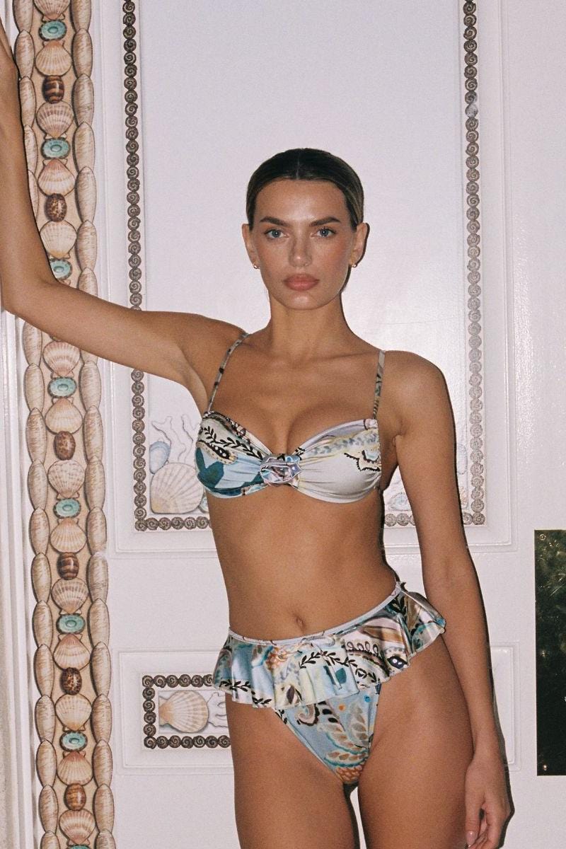 White bikini bottom with multicolored floral print and ruffle trim detail at leg openings.