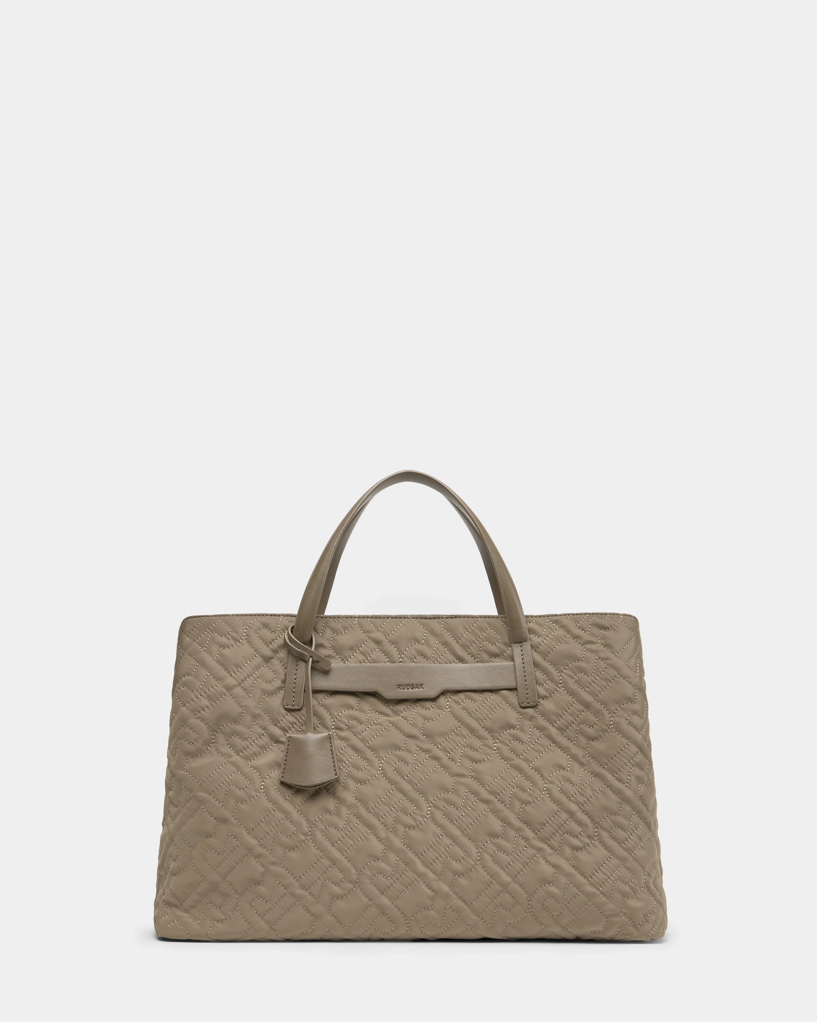 The Rudsak ASMINE - L325005 Almond is a taupe-colored, quilted monogram tote with double top handles and a small hanging tag, displayed on a plain white background.