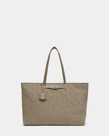 A stylish Rudsak LIVORNO - L325007 Almond tote bag in taupe quilted design, featuring two long handles and a decorative leather tag, displayed against a plain white background—everyday luxury redefined.