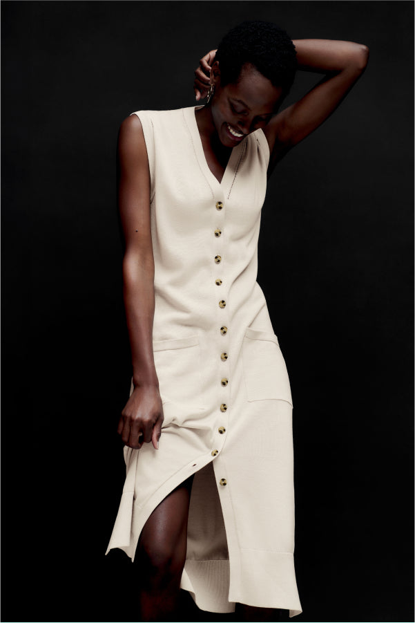 front image of a woman wearing the toula dress in ivory | Exclude | ALT GRID