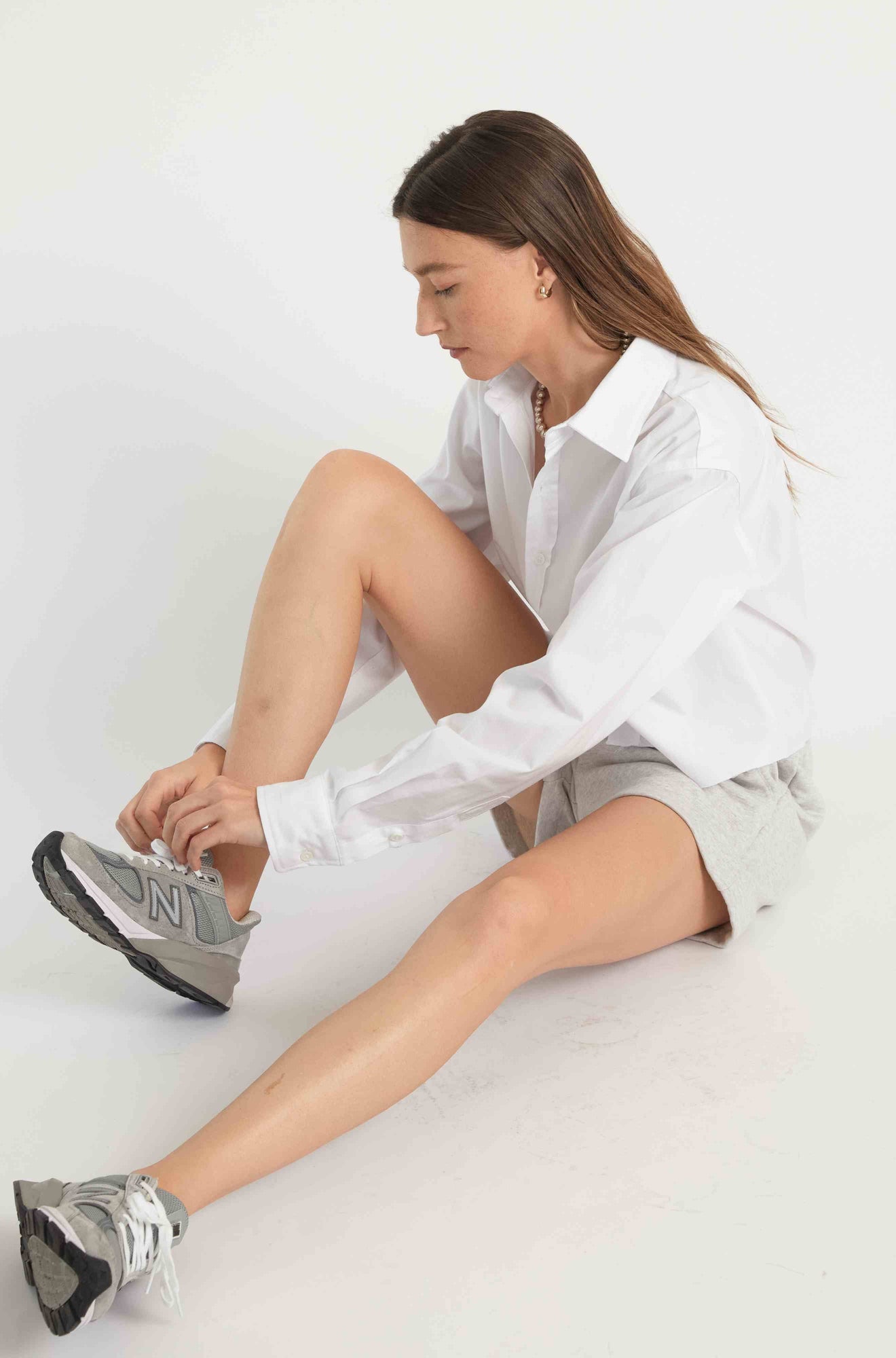 Woman wearing grey sweatshorts