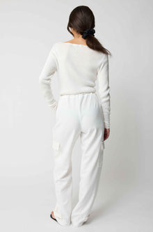 Person wearing a white outfit on a plain background